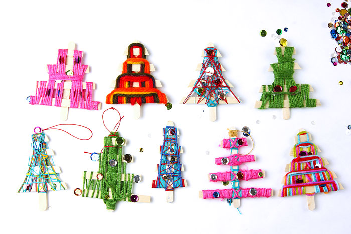 Make homemade Christmas ornaments from craft sticks and string/yarn. Fun holiday weaving project for kids.