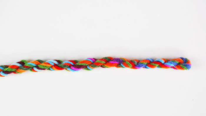 Easy and colorful yarn craft: Learn how to make rope out of a few strands of loose yarn.