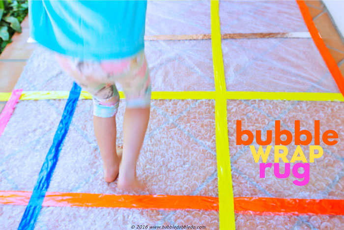Simple craft idea: Turn leftover bubble wrap into a rug for some sensory fun!