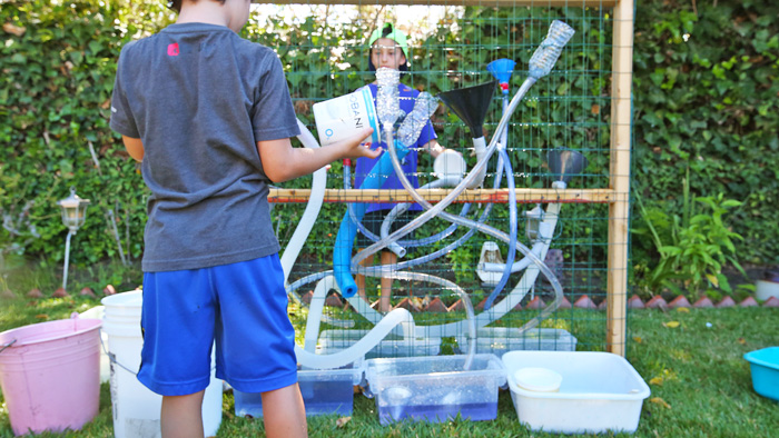 A DIY water wall is a great outdoor activity for kids! Learn how to build freestanding water wall for about $40 in materials.