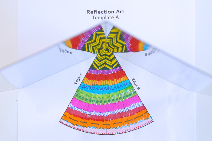 Reflection art for kids showing the template in use.